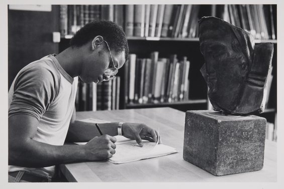 Old photo of a student studying in the library