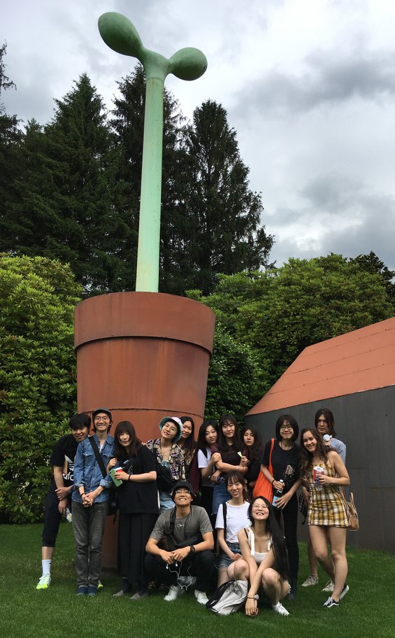 A group of CCA students at the base of a large outdoor sculpture at the Alessi Museum, in Omegna-Crusinallo, Italy, in 2019