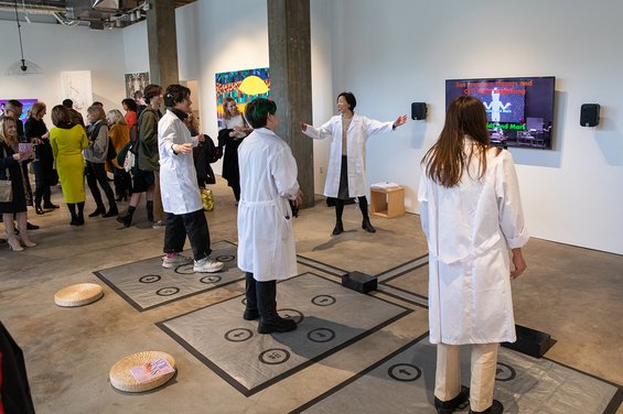 A class visits the Take Action exhibition at the Hubbell Street Galleries in fall 2018.