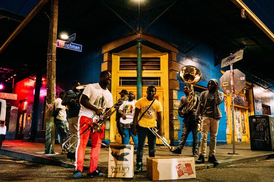Musicians playing on a street corner at night
