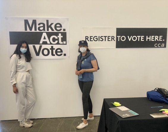 CCA Community Voting Organizers in front of wall with "Make Act Vote" sign