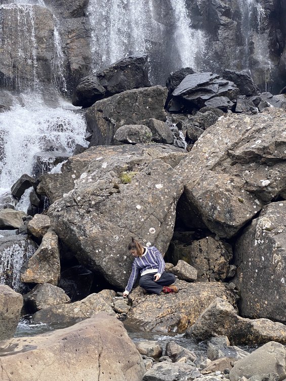 CCA student in front of waterfall.