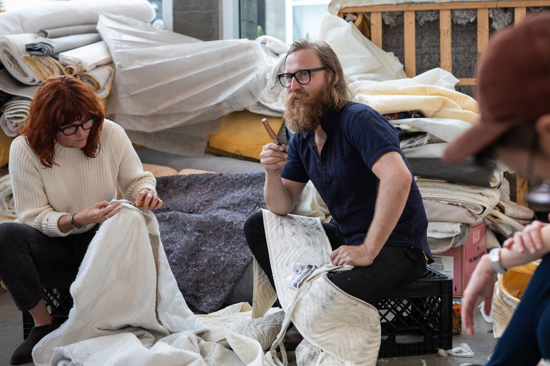Zachary Royer Scholz and friends dismantling mattresses during his residency at the Hubbell Street Galleries, summer 2019