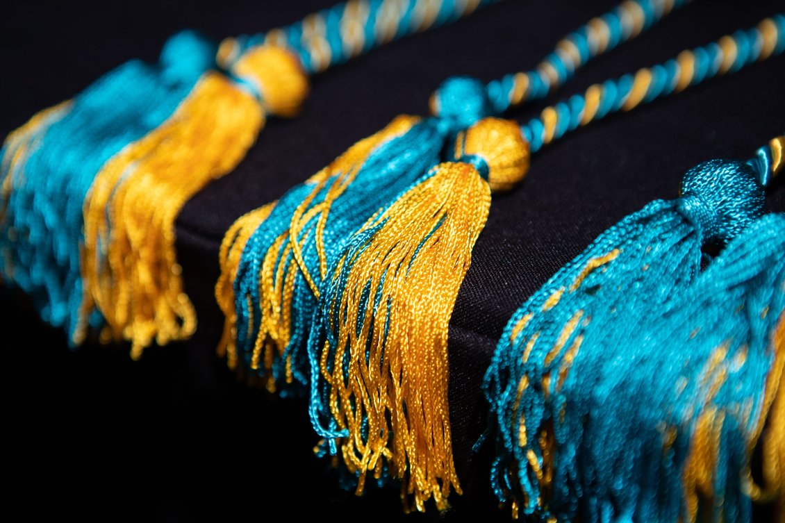 Teal and Gold honor cords are given to participants at the Multicultural Commencement Celebration